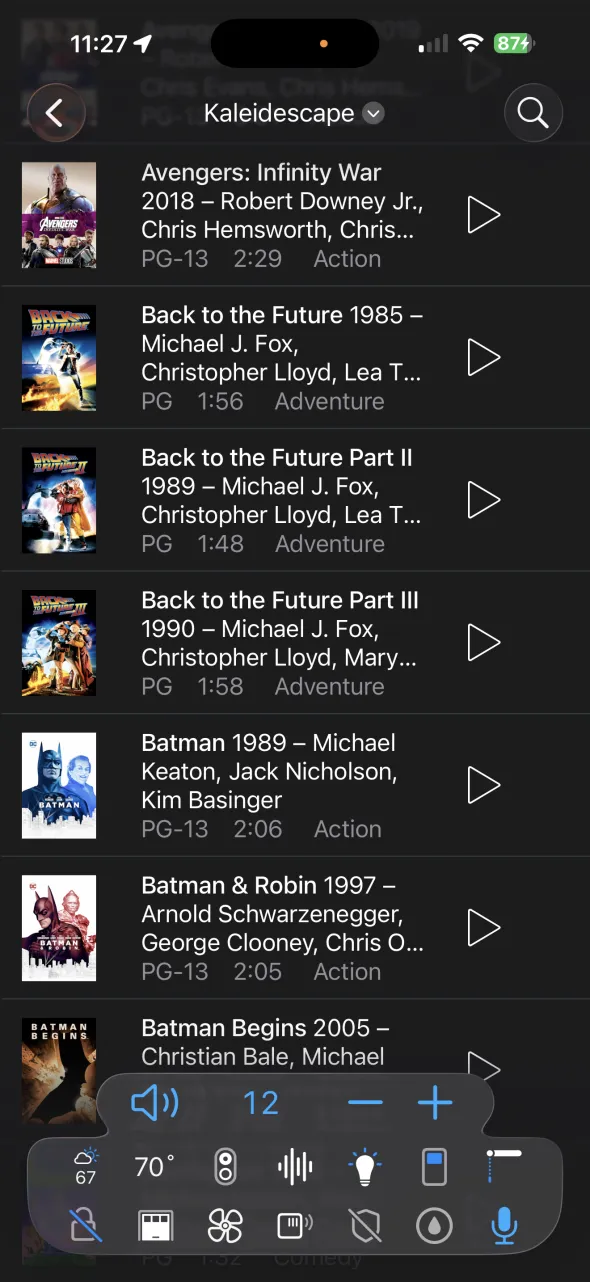Roomie's Media Guide on iPhone listing a Kaleidescape movie library with posters: Avengers: Infinity War, the Back to the Future trilogy, Batman, Batman & Robin, and Batman Begins, each with year, cast, rating, running time, genre, and a play button
